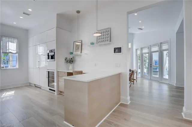 a view of a kitchen with furniture and wooden floor
