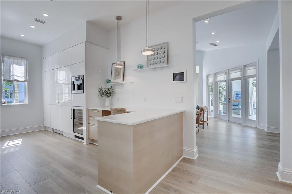 687 9th Avenue South Naples, FL 34102 - Photo 15 of 39 a view of a kitchen with furniture and wooden floor