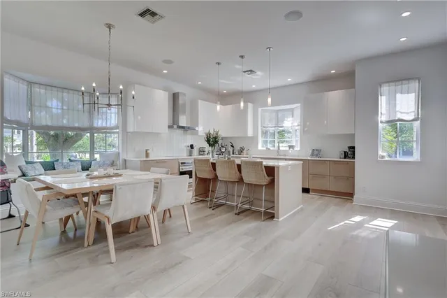 a kitchen with counter space cabinets dining table and chairs