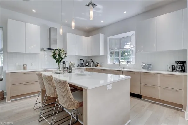 a kitchen with kitchen island granite countertop a sink a center island and cabinets