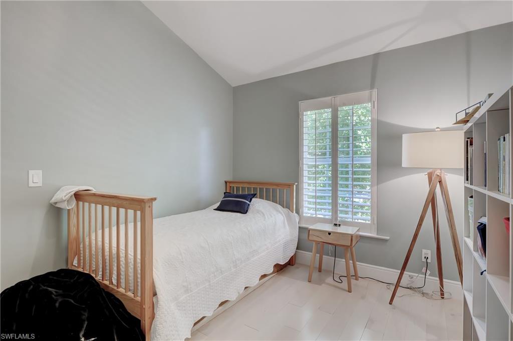 687 9th Avenue South Naples, FL 34102 - Photo 27 of 39 a bedroom with a bed chair and a window