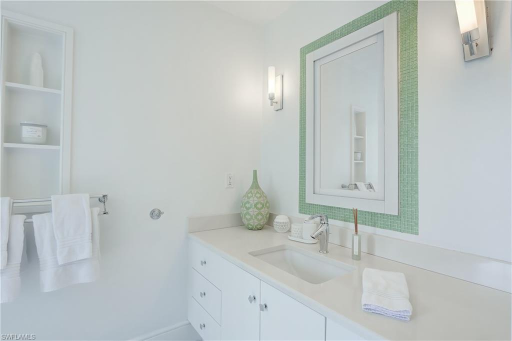 687 9th Avenue South Naples, FL 34102 - Photo 29 of 39 a bathroom with a sink and a mirror