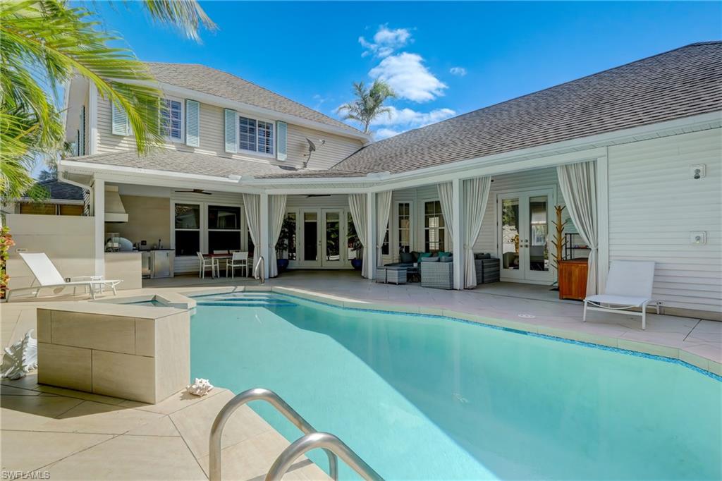 687 9th Avenue South Naples, FL 34102 - Photo 3 of 39 a view of a house with a swimming pool