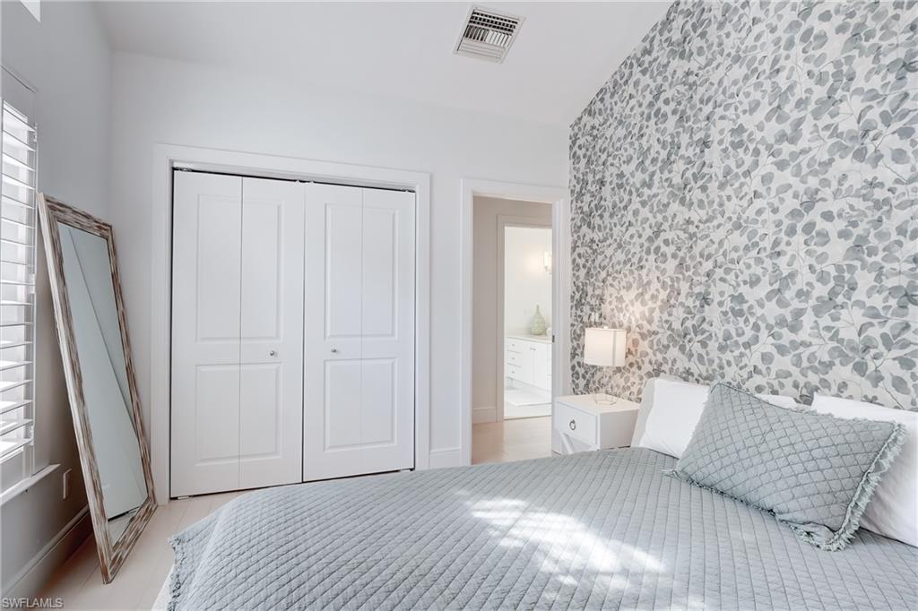687 9th Avenue South Naples, FL 34102 - Photo 31 of 39 a bedroom with a bed and a window