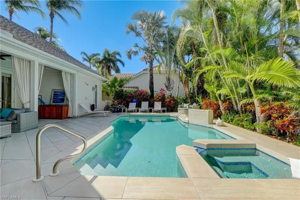 a view of a swimming pool with outdoor seating