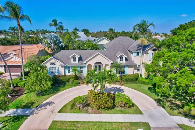 an aerial view of residential houses with outdoor space and parking
