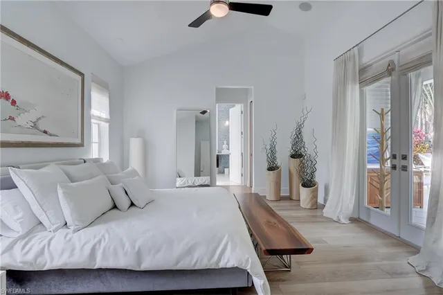 a bedroom with a bed and a chandelier