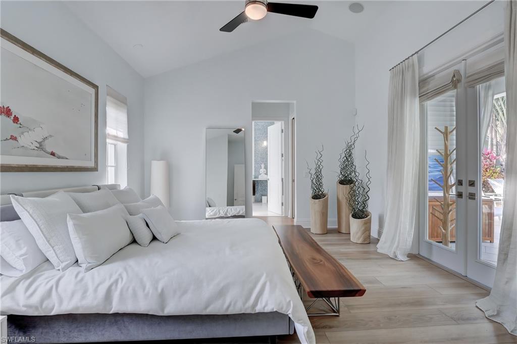 687 9th Avenue South Naples, FL 34102 - Photo 5 of 39 a bedroom with a bed and a chandelier