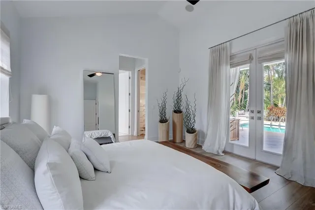 a bedroom with a bed and a large window