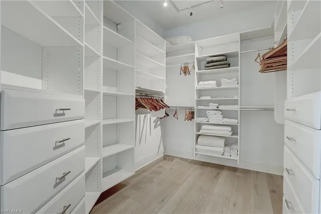 a view of walk in closet with empty racks