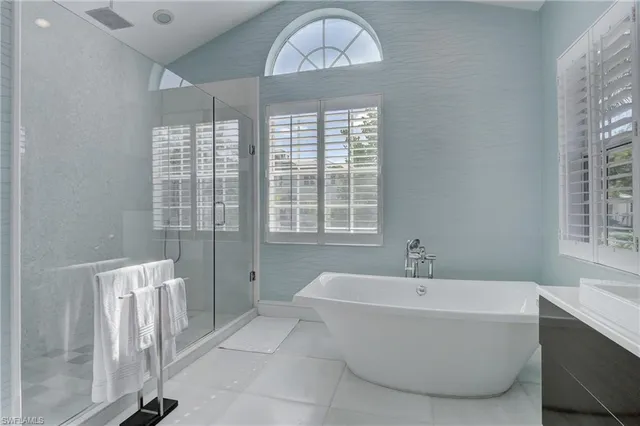 a bathroom with a bathtub and a window