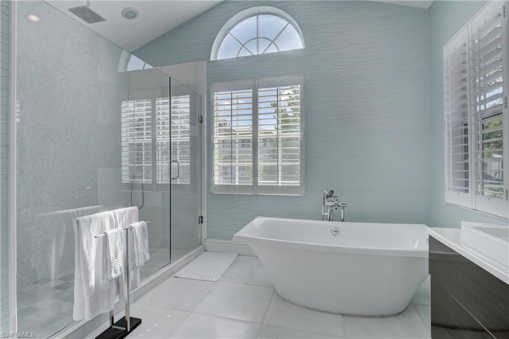 687 9th Avenue South Naples, FL 34102 - Photo 9 of 39 a bathroom with a bathtub and a window
