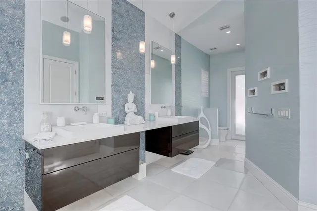 a large bathroom with a double vanity sink a mirror and a shower
