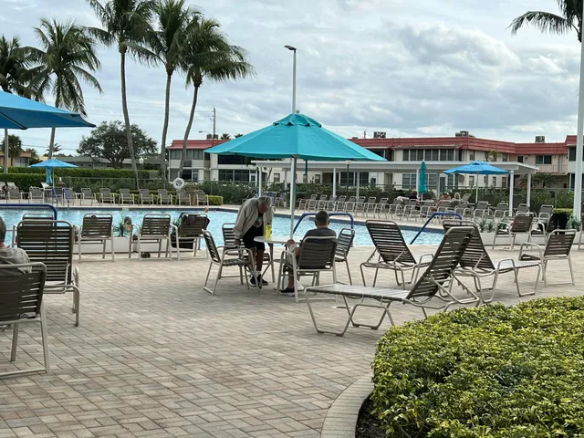 a view of a swimming pool and chairs in patio