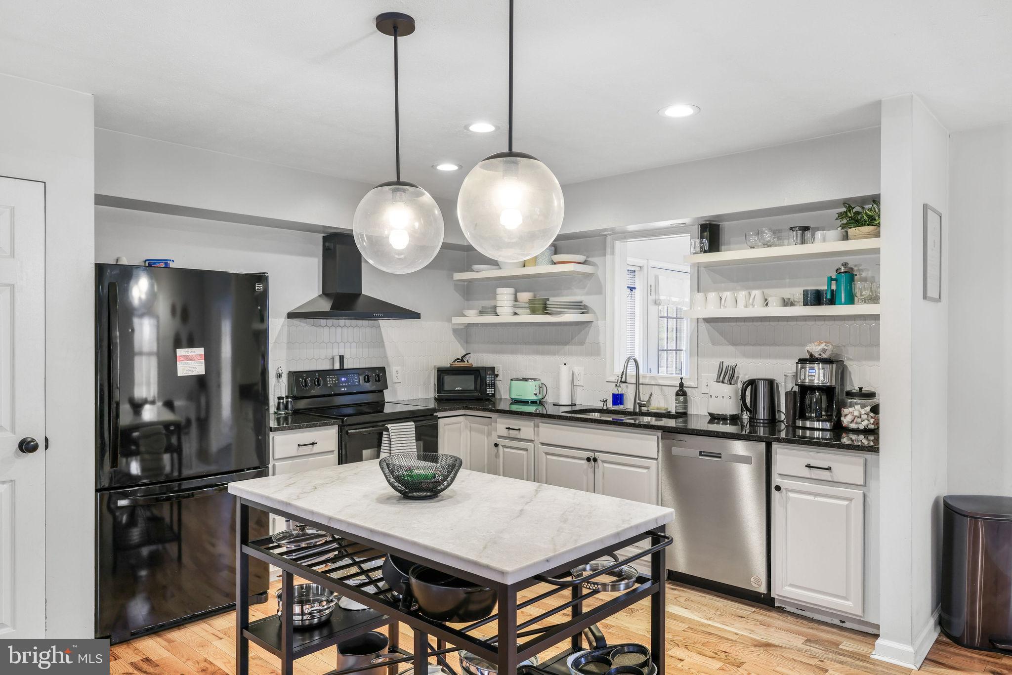 323 Palmer Road Basye, VA 22810 - Photo 27 of 30 a kitchen with a dining table cabinets and stainless steel appliances