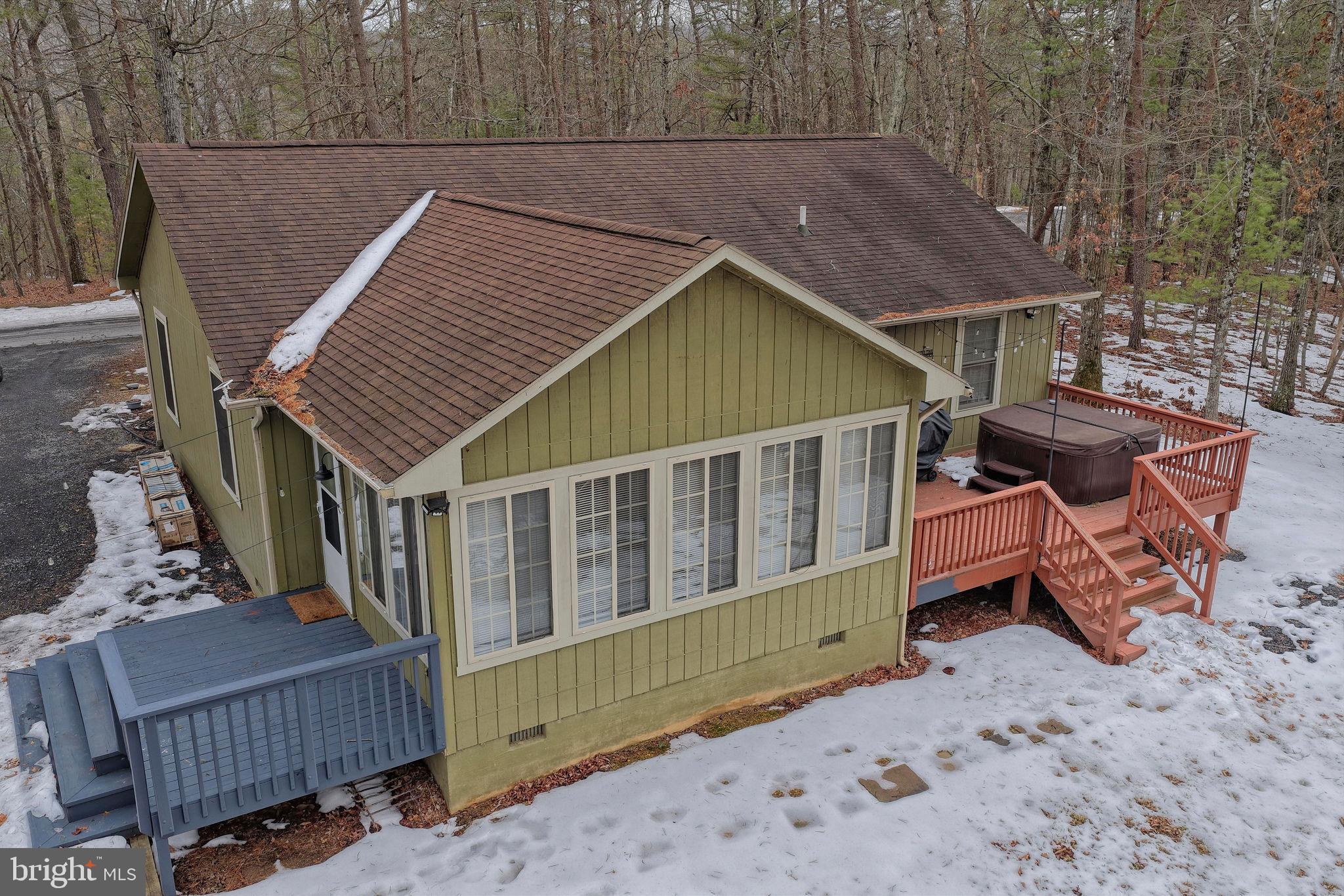 323 Palmer Road Basye, VA 22810 - Photo 10 of 30 an outdoor view of house with wooden deck and furniture