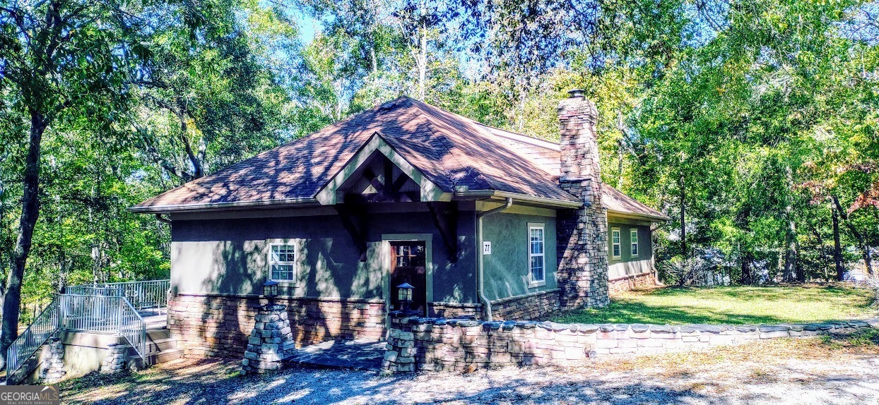 77 Paradise Cove Hartwell, GA 30643 - Photo 2 of 21 a front view of a house with garden