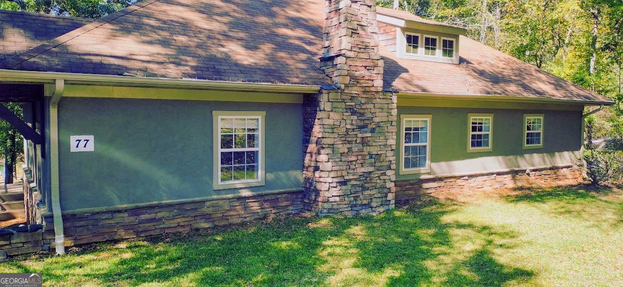 77 Paradise Cove Hartwell, GA 30643 - Photo 4 of 21 a front view of a house with a yard