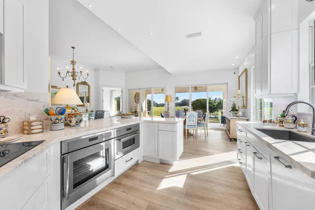 a large white kitchen with a large window