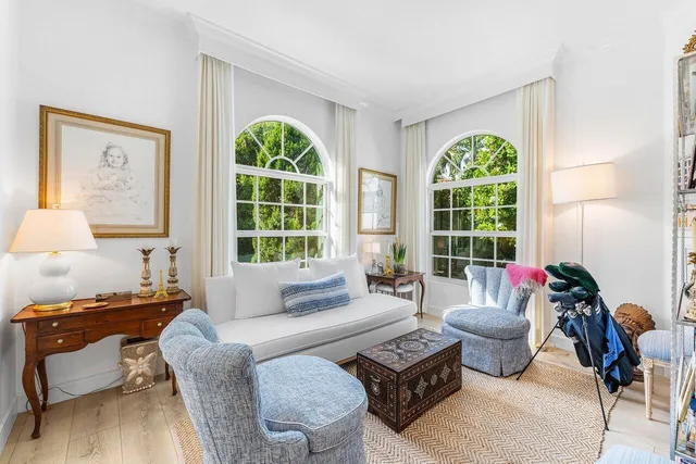 a living room with furniture and a book shelf