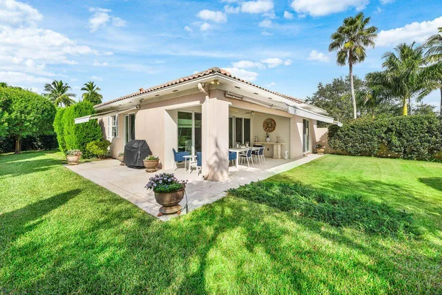 a view of a patio with couches chairs and a yard