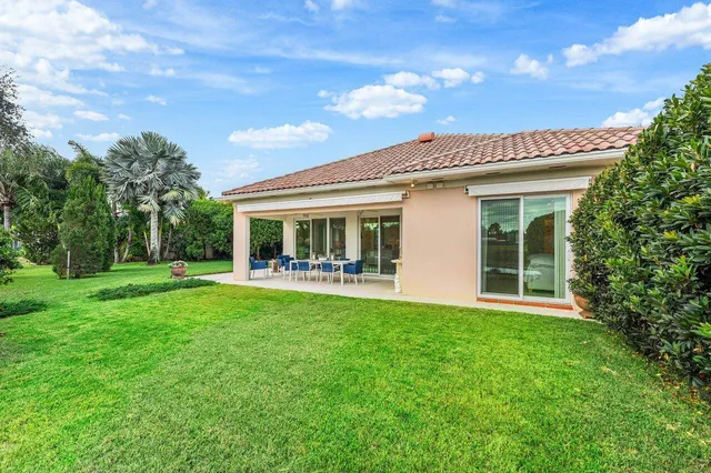 a view of a house with a yard and plants