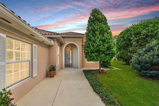 a front view of a house with a garden