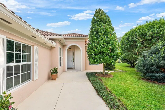 an aerial view of a house with yard swimming pool and lake view