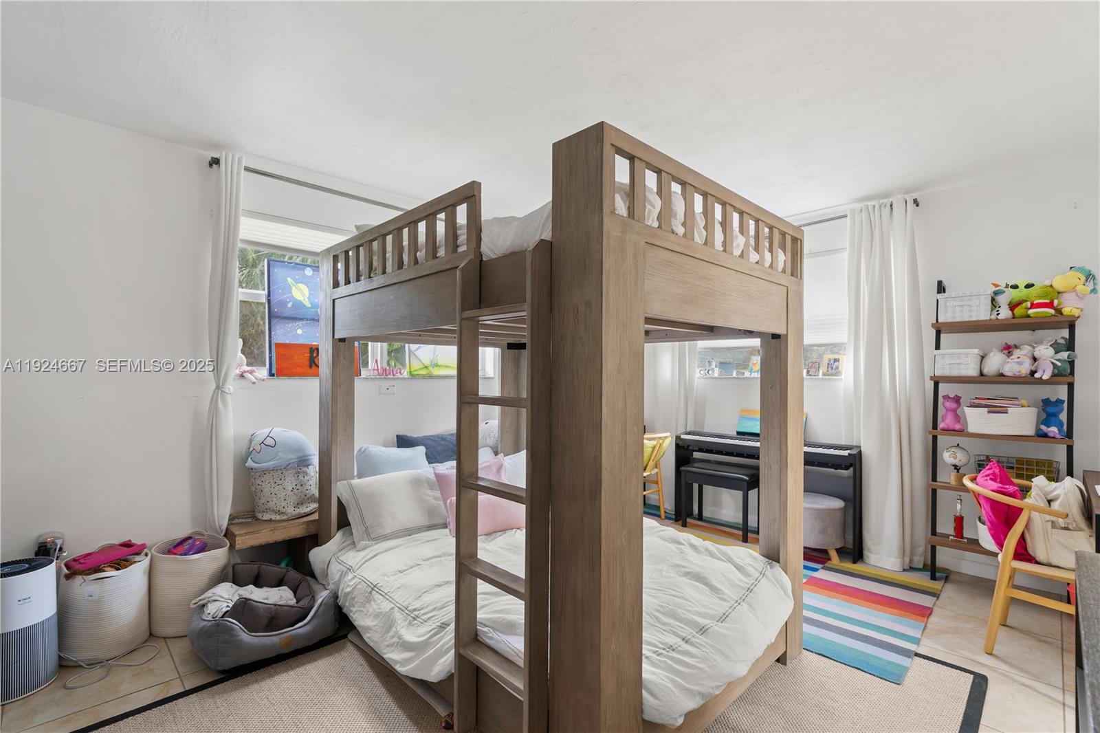 555 Crandon Boulevard, Unit 21 Key Biscayne, FL 33149 - Photo 11 of 32 a bedroom with furniture and a book shelf