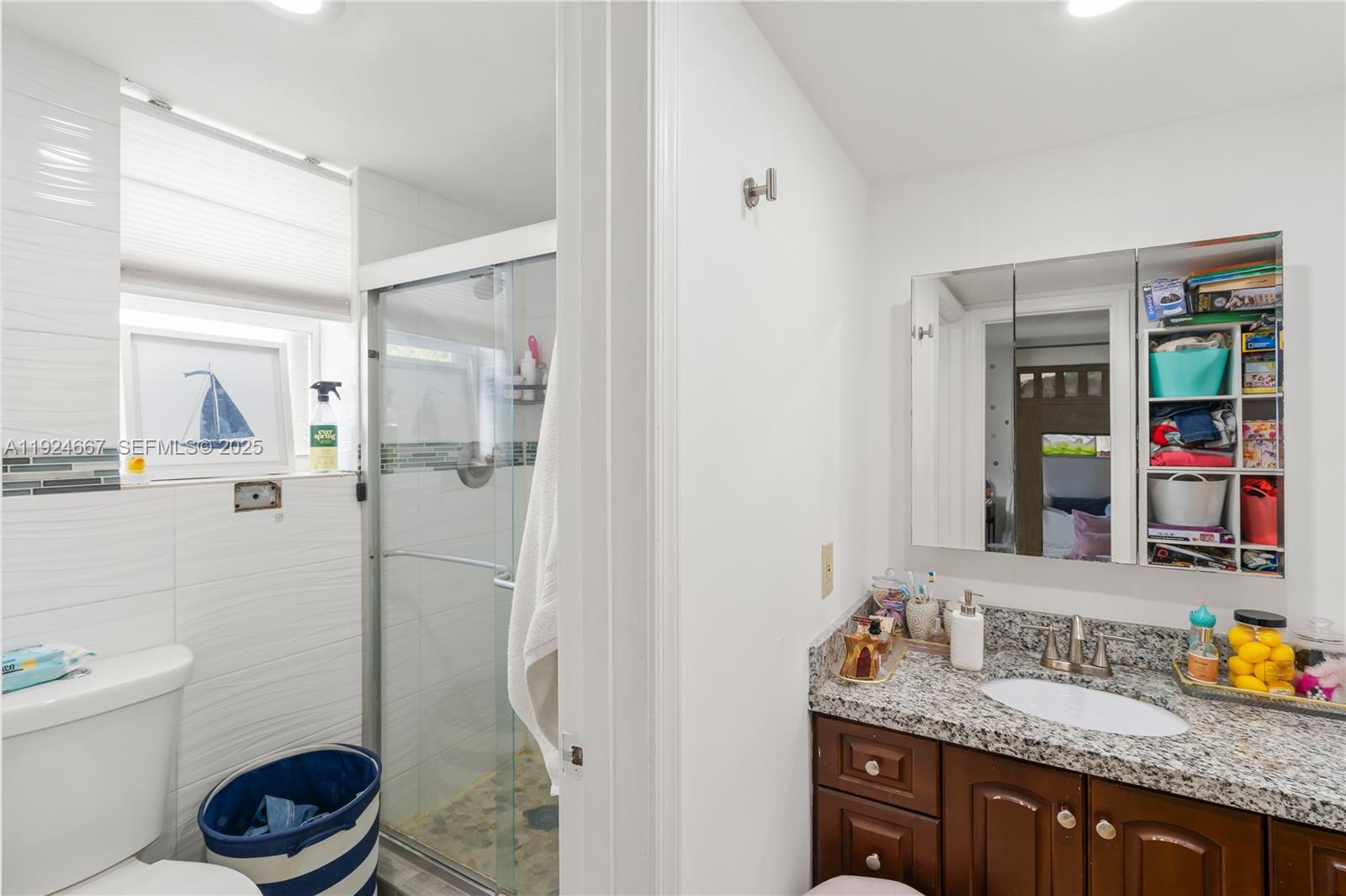 555 Crandon Boulevard, Unit 21 Key Biscayne, FL 33149 - Photo 13 of 32 a bathroom with a granite countertop sink toilet and shower