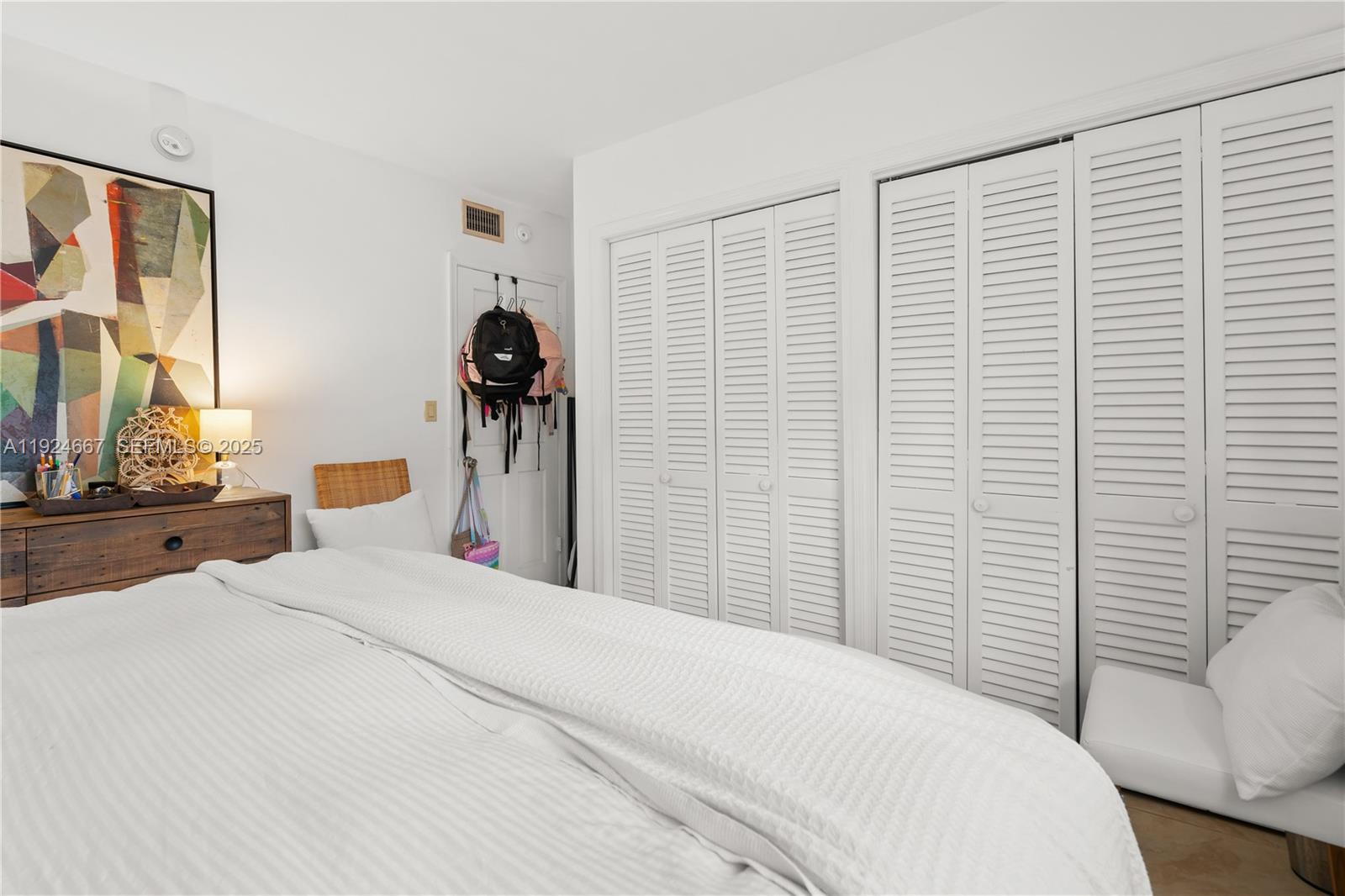 555 Crandon Boulevard, Unit 21 Key Biscayne, FL 33149 - Photo 14 of 32 a bedroom with a bed and a lamp
