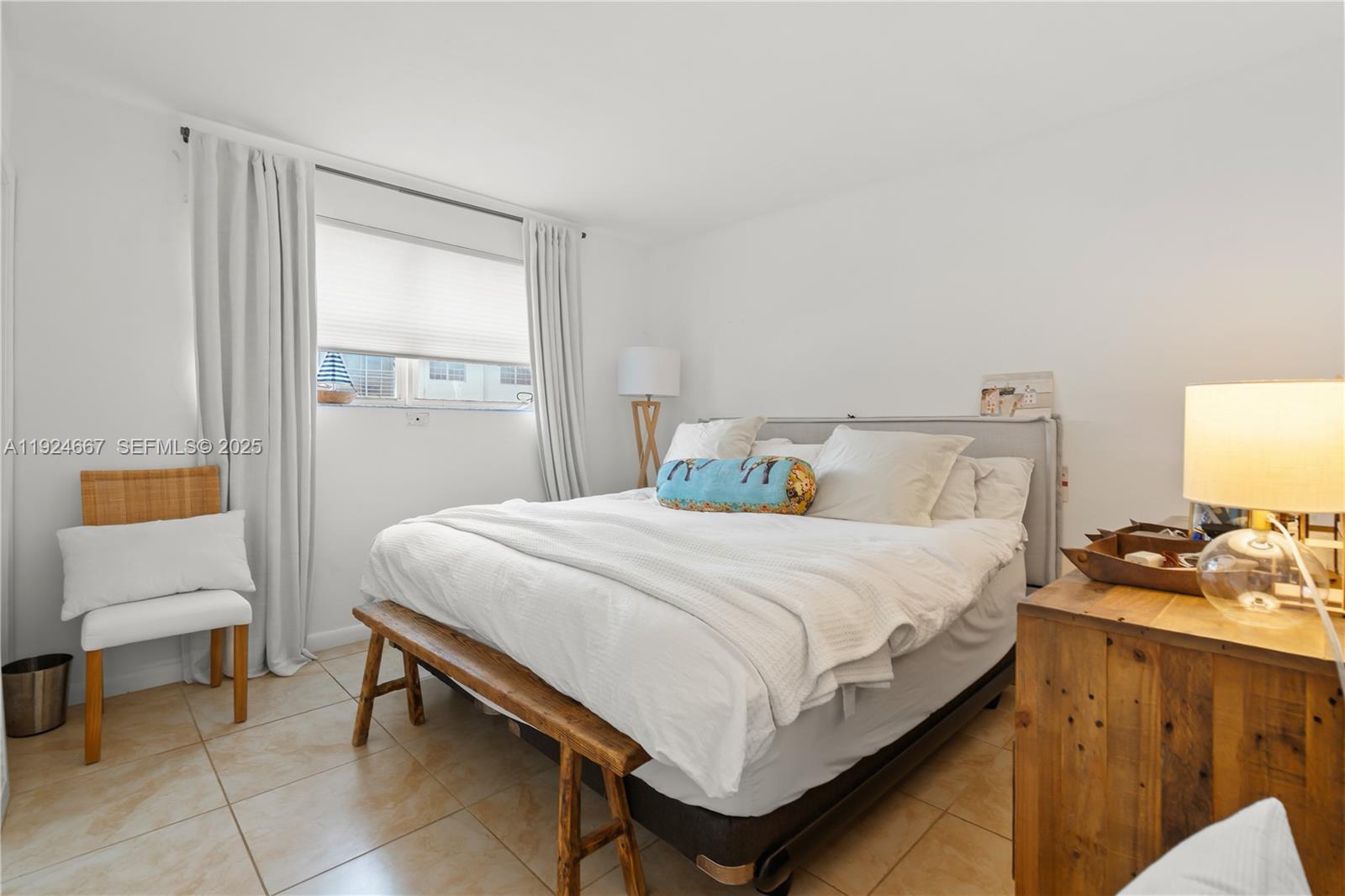 555 Crandon Boulevard, Unit 21 Key Biscayne, FL 33149 - Photo 15 of 32 a bedroom with a bed and a window