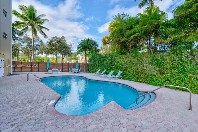 a view of a swimming pool with a yard