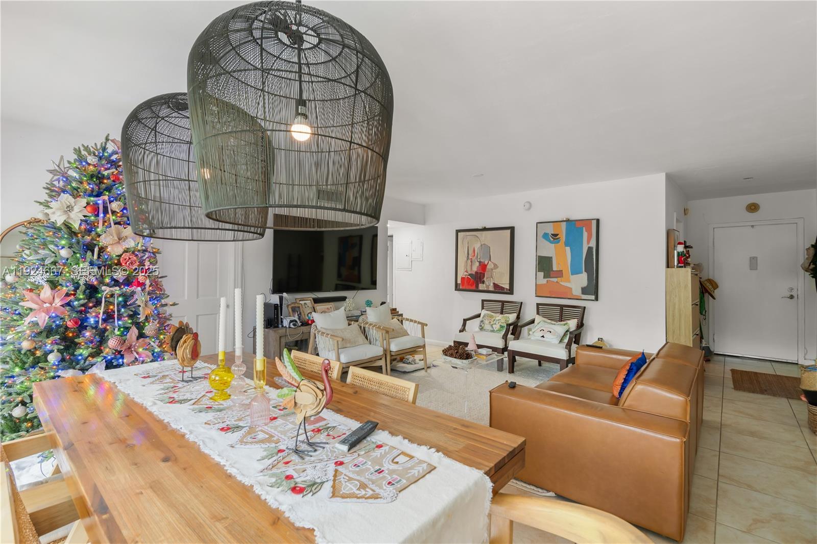 555 Crandon Boulevard, Unit 21 Key Biscayne, FL 33149 - Photo 3 of 32 a living room with furniture flowers and a chandelier