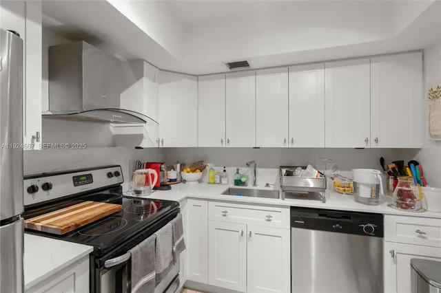 a kitchen with stainless steel appliances granite countertop a sink stove and cabinets
