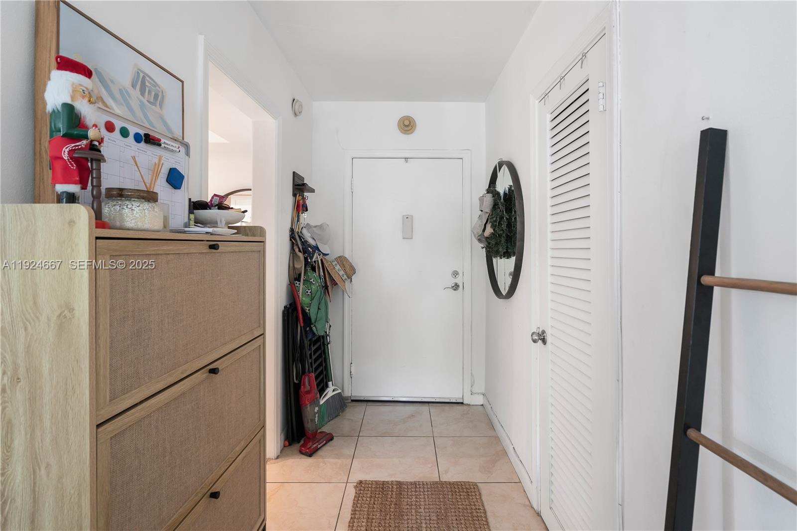 555 Crandon Boulevard, Unit 21 Key Biscayne, FL 33149 - Photo 9 of 32 a view of walk in closet with clothes and shoes