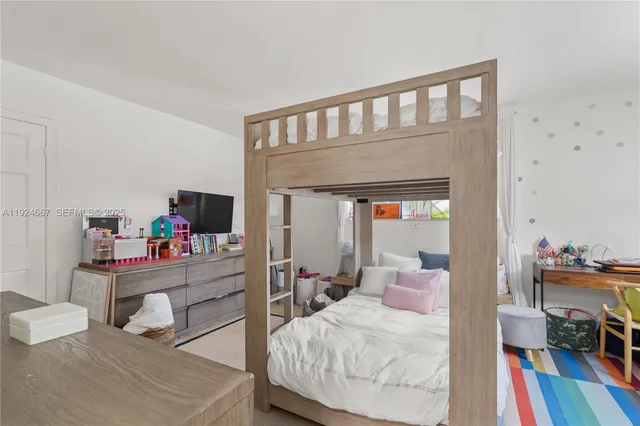 a bedroom with furniture and a book shelf