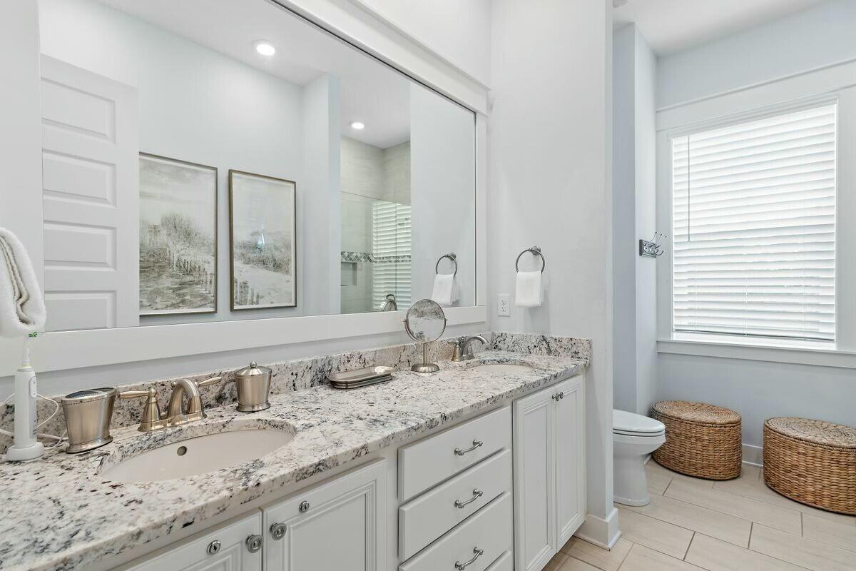 58 East Milestone Dr Inlet Beach, Unit B Inlet Beach, FL 32461 - Photo 20 of 47 a bathroom with a granite countertop sink and a large mirror