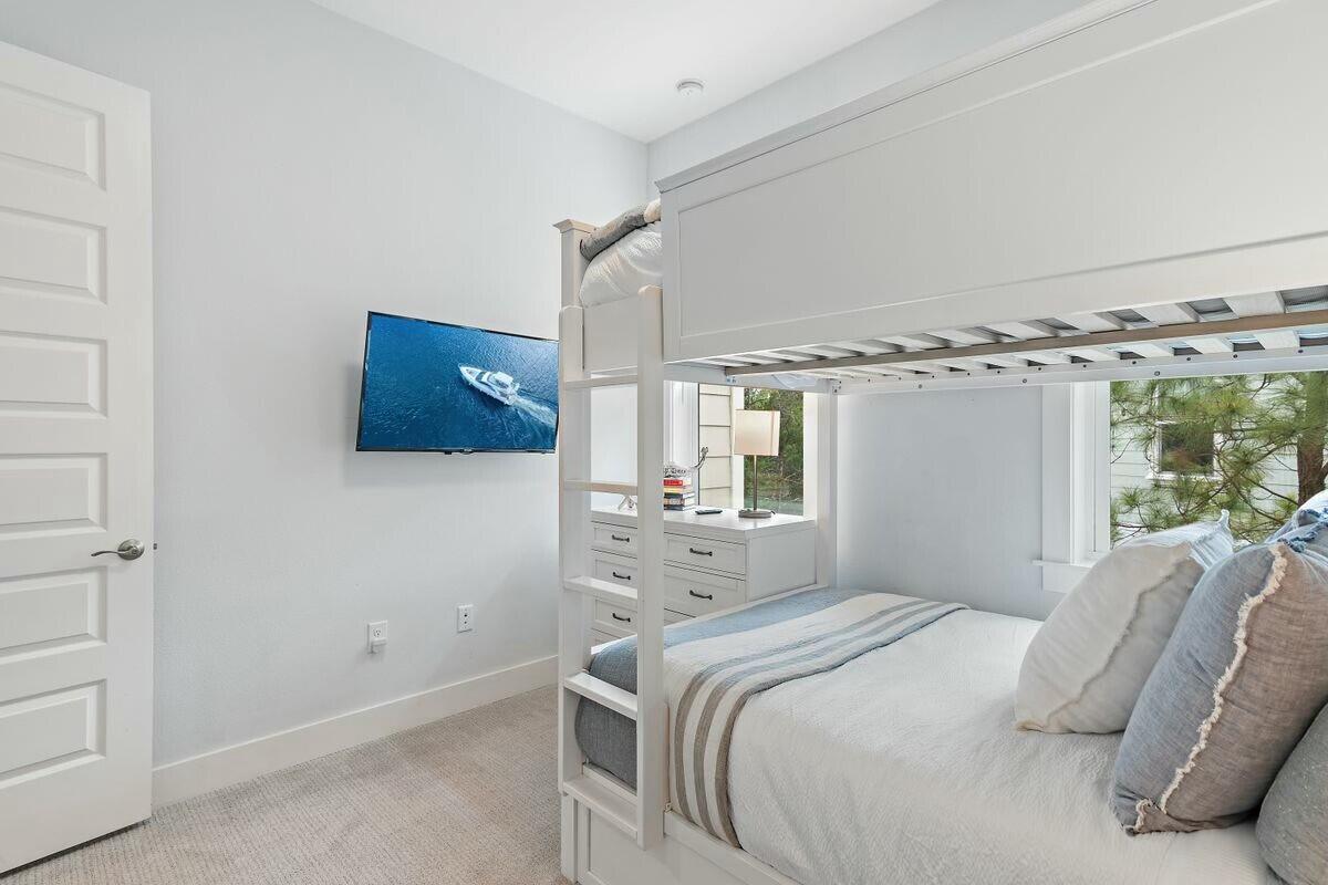 58 East Milestone Dr Inlet Beach, Unit B Inlet Beach, FL 32461 - Photo 23 of 47 a bedroom with a bed mirror and window