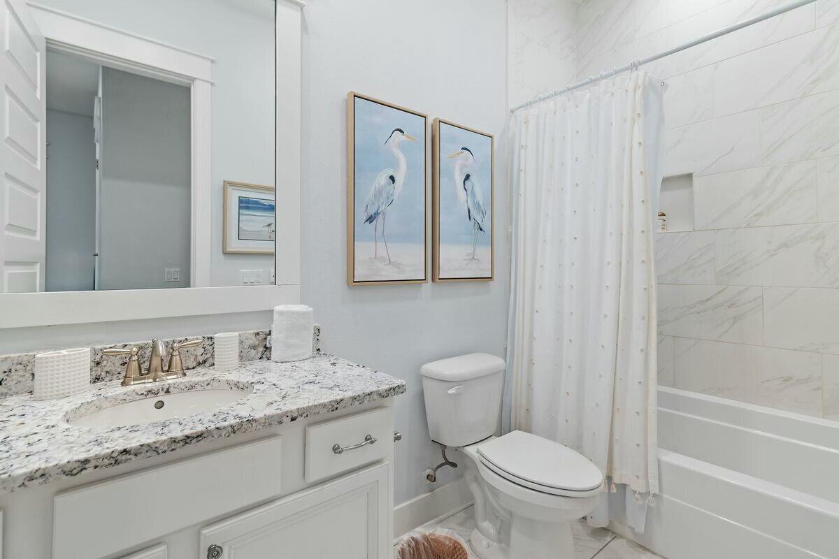 58 East Milestone Dr Inlet Beach, Unit B Inlet Beach, FL 32461 - Photo 24 of 47 a bathroom with a granite countertop toilet a sink and a bathtub