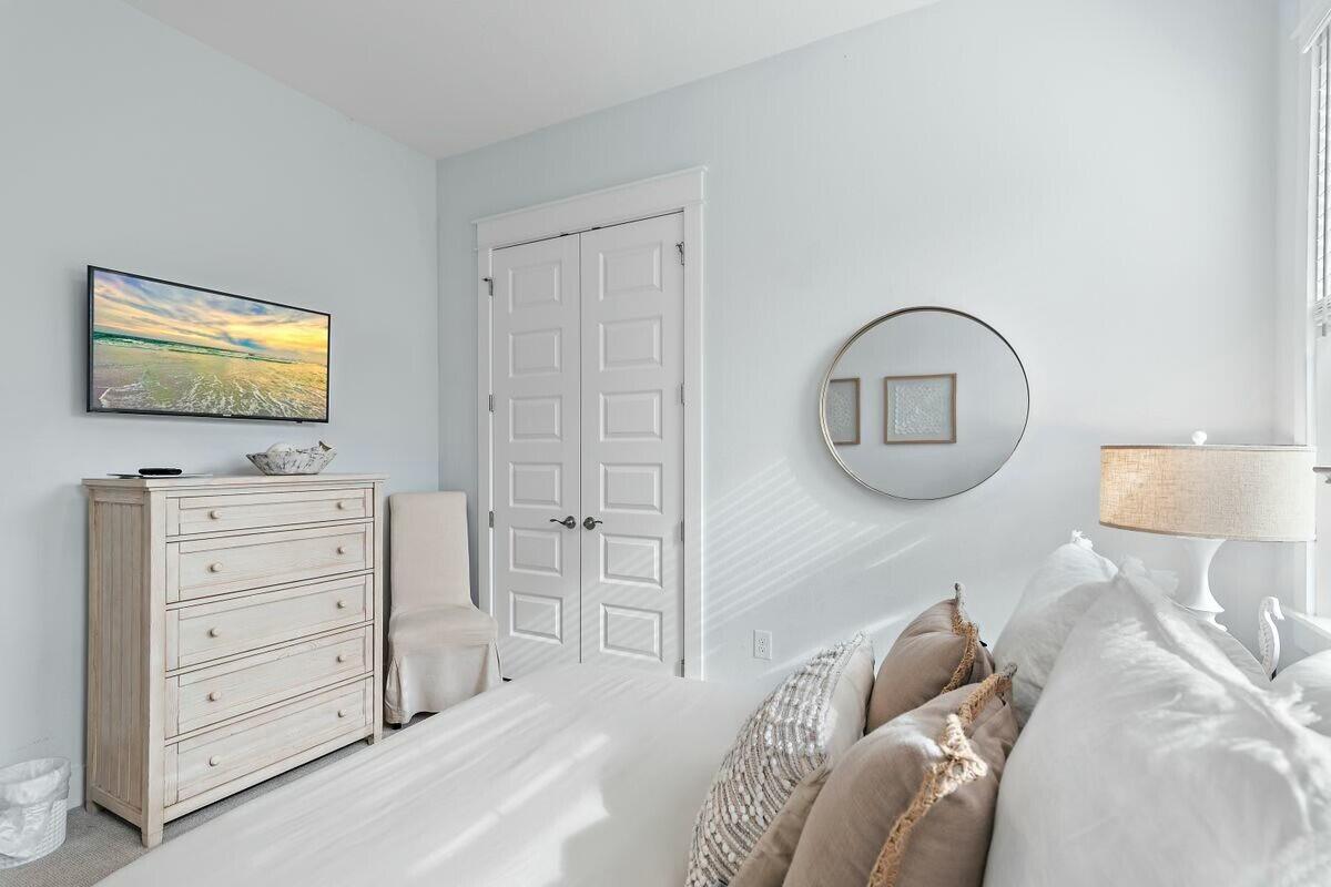 58 East Milestone Dr Inlet Beach, Unit B Inlet Beach, FL 32461 - Photo 26 of 47 a bedroom with a bed and a flat screen tv