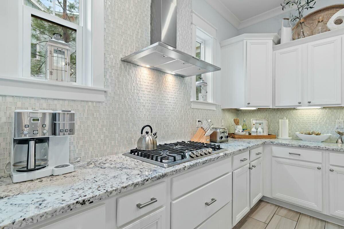 58 East Milestone Dr Inlet Beach, Unit B Inlet Beach, FL 32461 - Photo 9 of 47 a kitchen with stainless steel appliances granite countertop a sink stove and cabinets