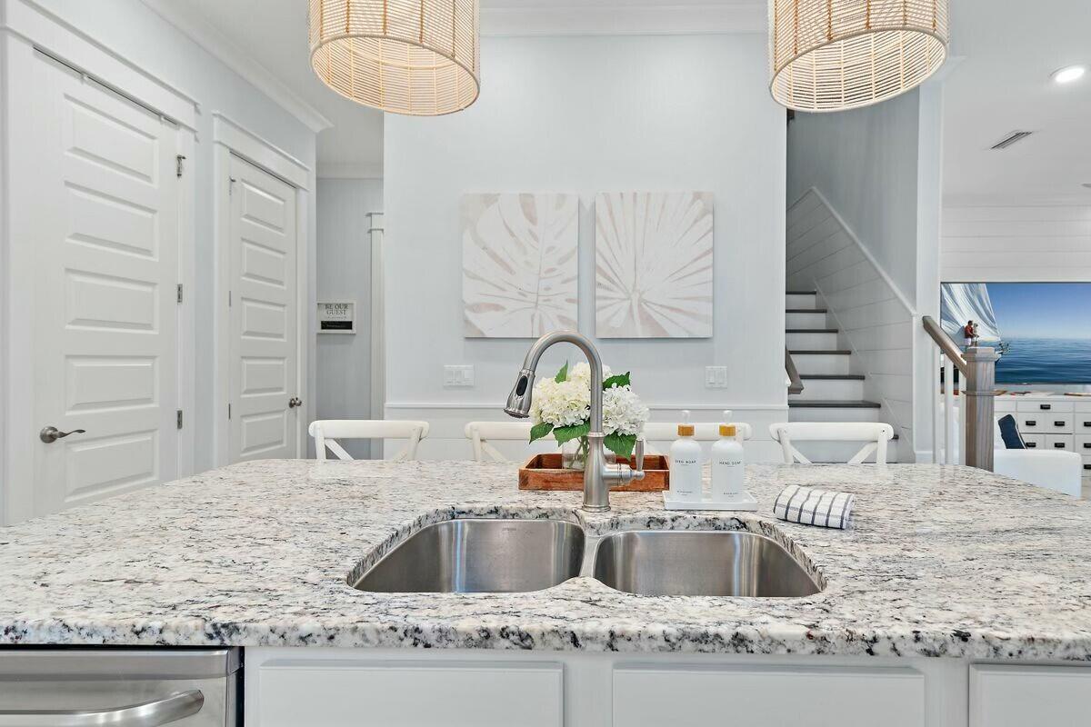 58 East Milestone Dr Inlet Beach, Unit B Inlet Beach, FL 32461 - Photo 10 of 47 a kitchen with granite countertop a sink a counter and a stove