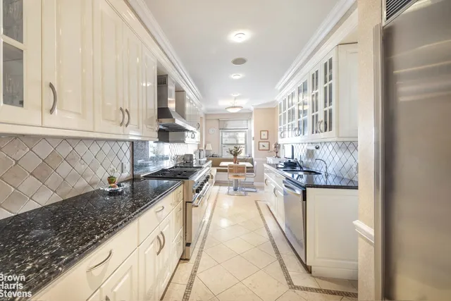 a bathroom with a granite countertop sink a toilet a mirror and shower