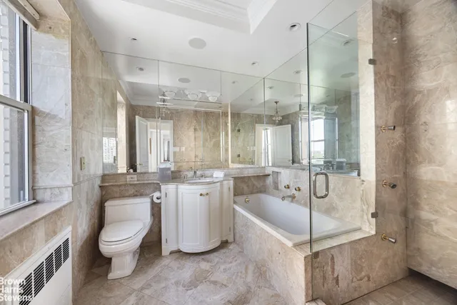 a spacious bedroom with a bed and a large window