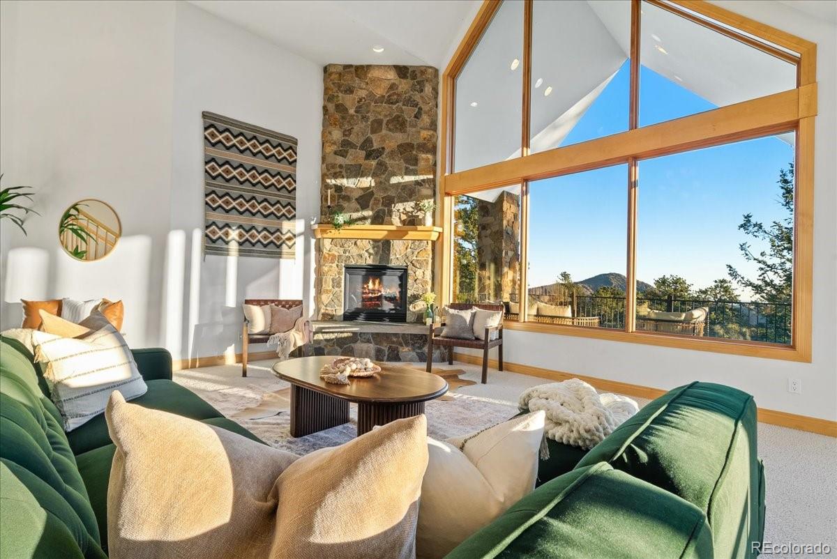 20682 Falcon Wing Road Indian Hills, CO 80454 - Photo 13 of 45 a living room with furniture and a large window