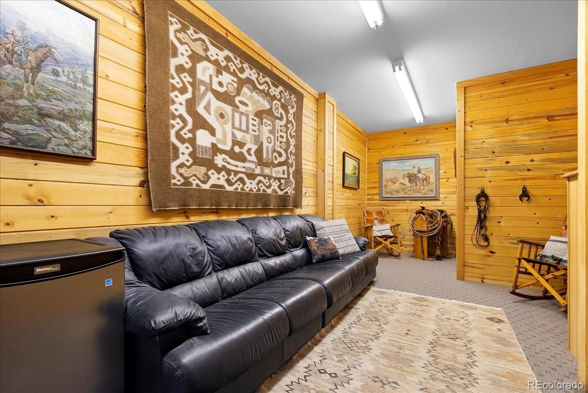 20682 Falcon Wing Road Indian Hills, CO 80454 - Photo 15 of 50 a living room with furniture and a flat screen tv