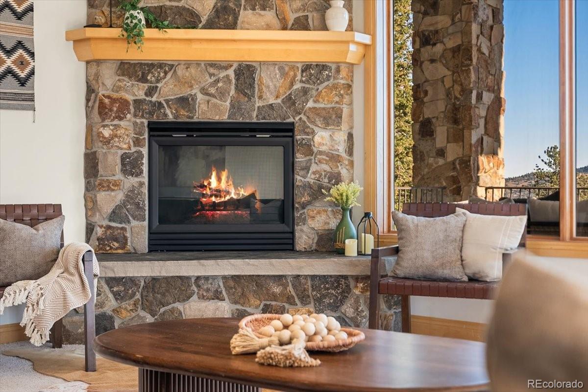 20682 Falcon Wing Road Indian Hills, CO 80454 - Photo 19 of 50 a living room with furniture and a fireplace