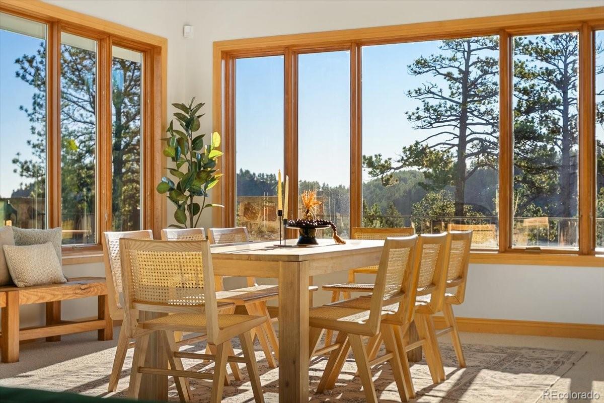 20682 Falcon Wing Road Indian Hills, CO 80454 - Photo 21 of 45 a very nice looking dining room with a large window and dining table