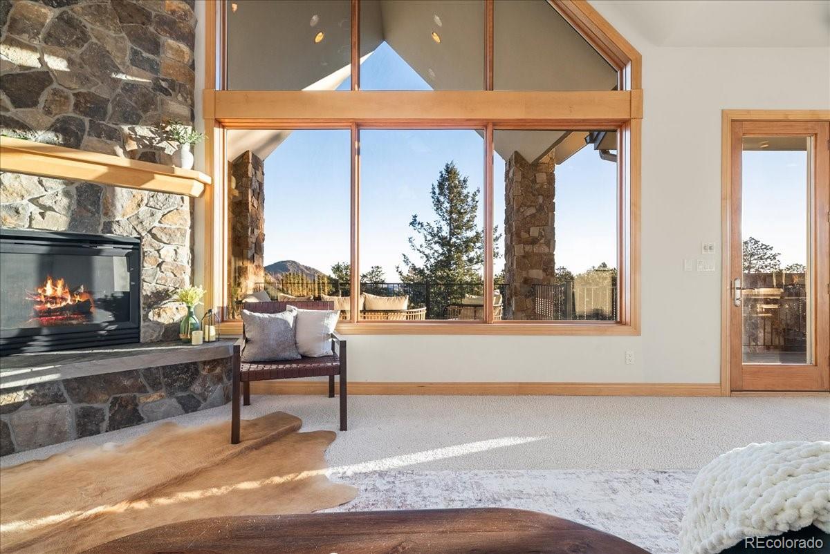 20682 Falcon Wing Road Indian Hills, CO 80454 - Photo 22 of 50 a living room with a couch and a fireplace